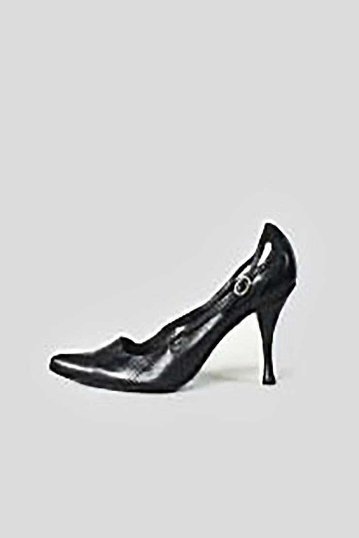 A black, pointed toe, leather pump with a side cut-out design and brass-tone accents on a white background.