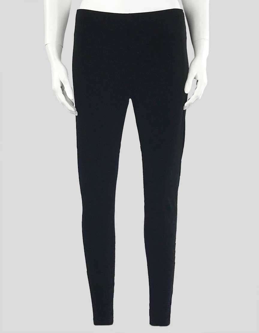 A pair of Eileen Fisher black velvet leggings displayed on a mannequin, showing the front view with an elasticated waist and pull-on style.