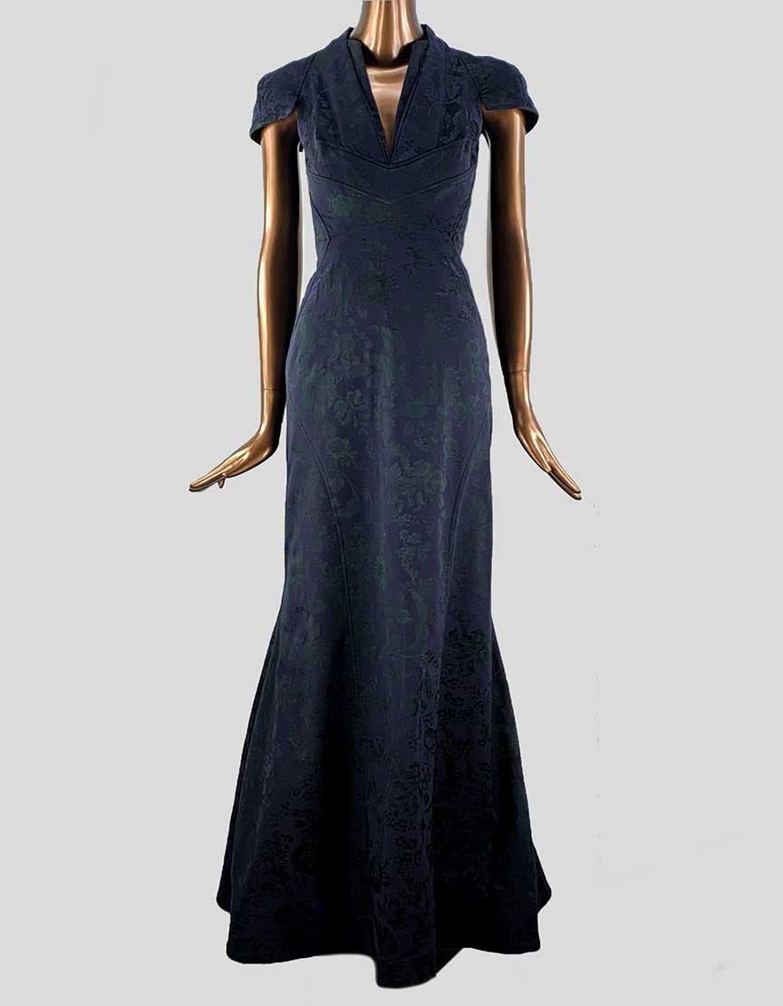 A dark blue, short-sleeved, high-low black-tie dress with a deep V neckline and embroidered floral print, displayed on a mannequin.
