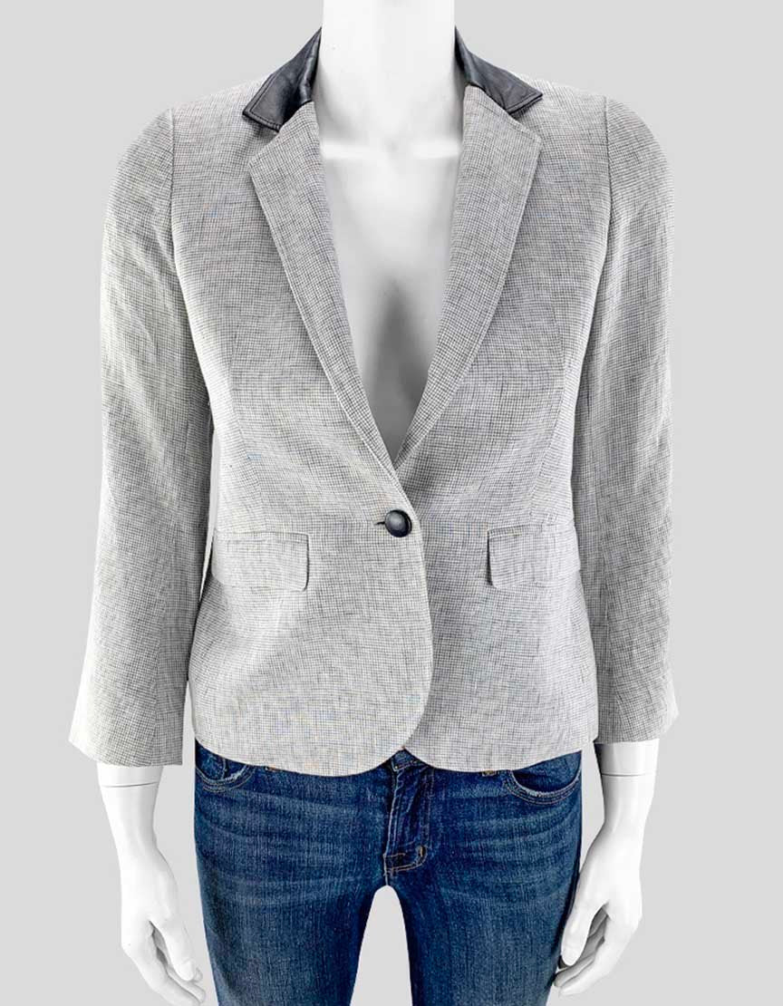 Grey plaid blazer with black leather collar and buttons, displayed on a mannequin.