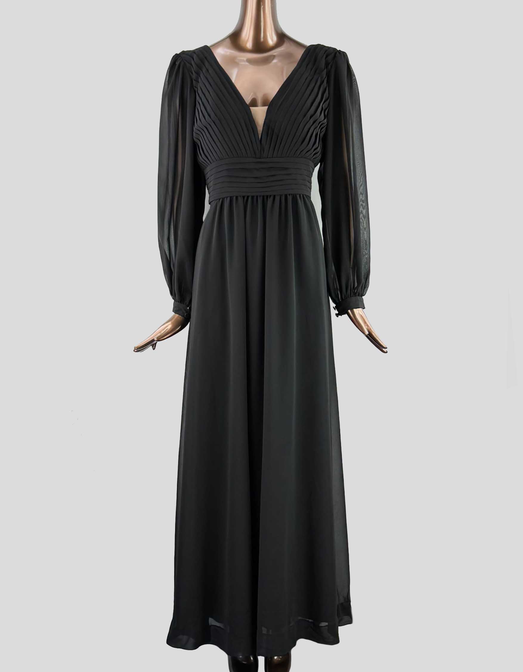 A long black dress with sheer sleeves, a V-neck, and pleated details at the bust and waist, displayed on a mannequin.
