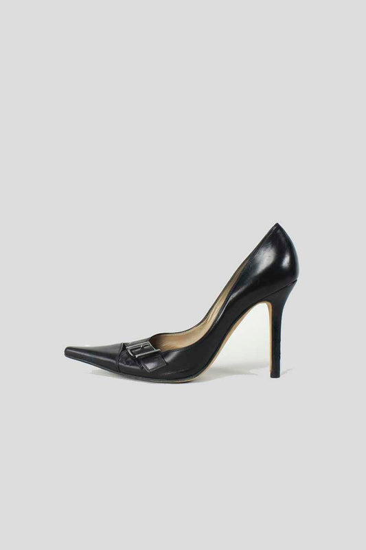 A pair of black leather pumps with silver-tone buckle accents and leather-covered heels.