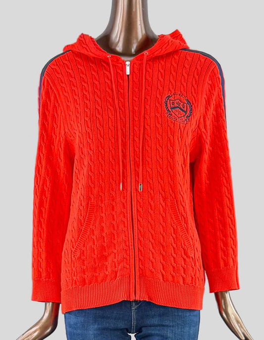 LAUREN RALPH LAUREN orange zip sweater with hoodie. Cable design throughout. Two front pockets. Blue stripe on sleeves. Navy blue RL insignia on front.