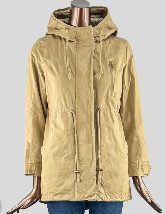 Outdoor jacket with hood in tan. Back vent detail. Shirttail hem that's longer in the back with snap closure. Waist tie. Zip and placket snap closure at front.