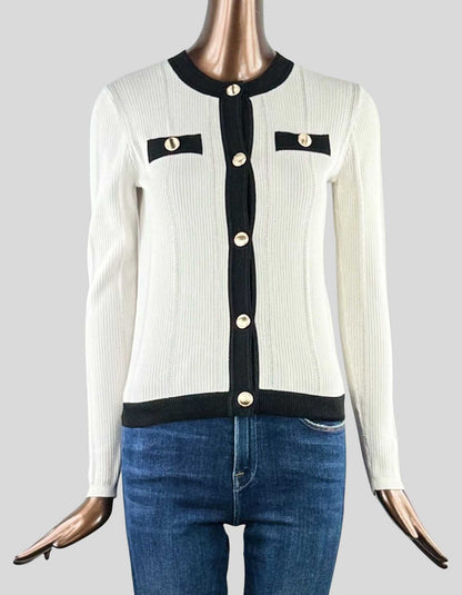 ANN TAYLOR Textured Sweater Jacket in white with black details. Crew neck. Front button closures. Gold-tone buttons throughout. Long sleeves. Faux front chest-welt pockets.