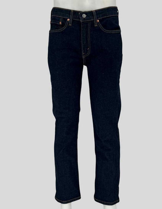 Authentic screen-worn Levi's 514 straight leg dark indigo denim jeans featuring classic five-pocket styling, signature red tab, and copper rivets. 