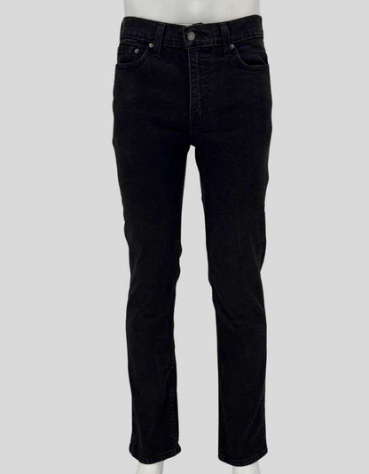 Authentic screen-worn Levi's 514 straight leg black denim jeans featuring classic five-pocket styling, signature red tab, and copper rivets.