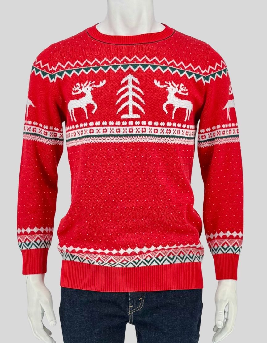 Authentic screen-worn Meaveor red Fair Isle Christmas sweater featuring reindeer, Christmas tree, and Nordic pattern design with white and green accents.