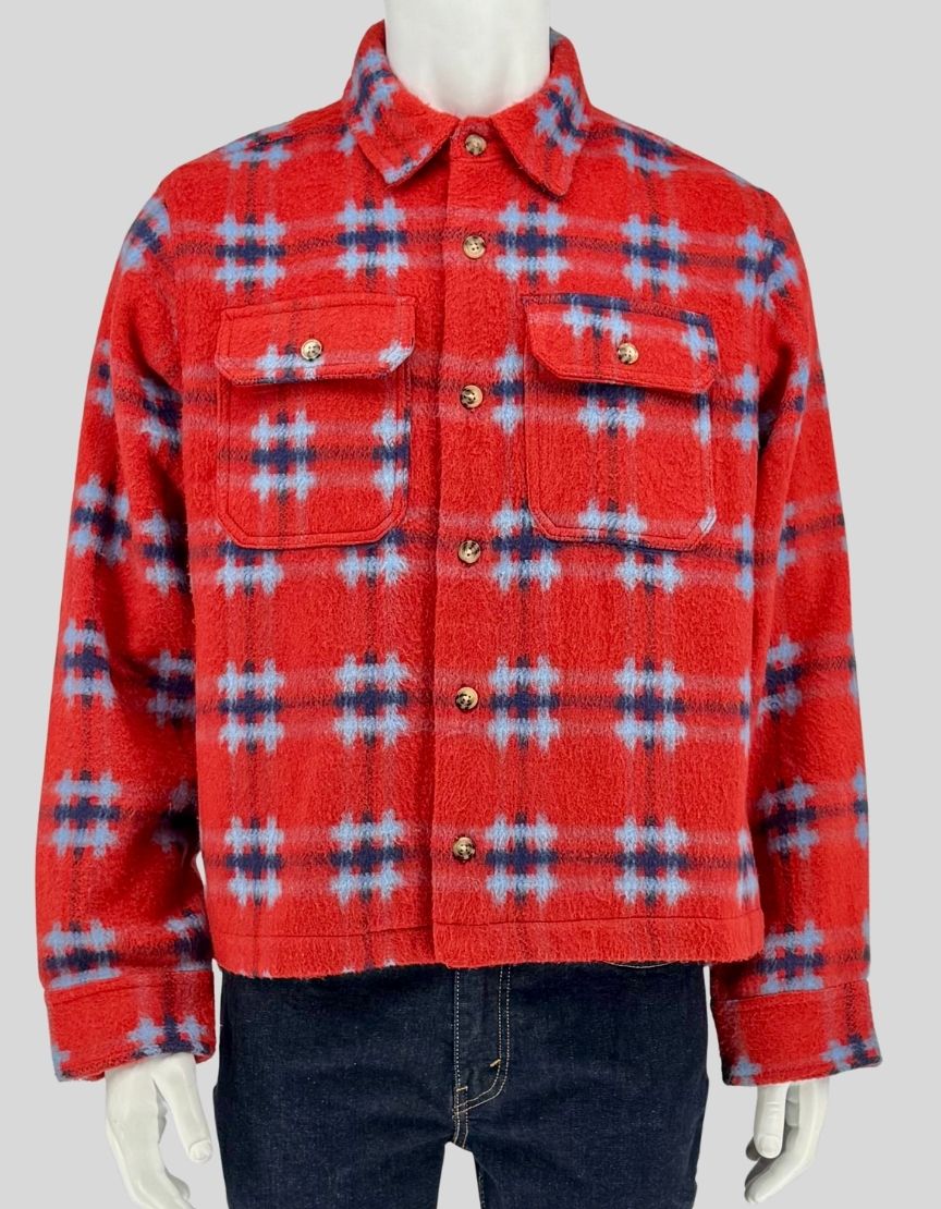 Authentic screen-worn BDG red plaid fleece shirt jacket featuring blue and navy windowpane pattern, dual chest pockets, and snap-button closure.