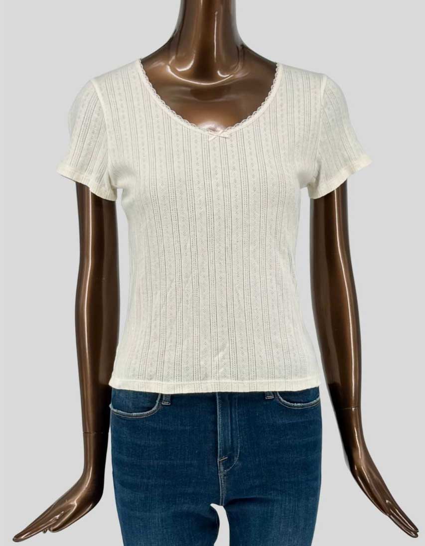 Authentic screen-worn Levi's cream ribbed knit v-neck tee featuring pointelle detailing, scalloped neckline, and short sleeves.