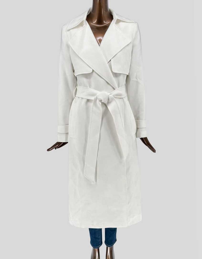 Authentic screen-worn Ever New cream belted trench coat featuring double-breasted front, epaulettes, self-tie belt, and traditional storm flaps.