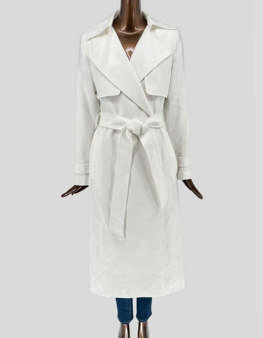 Authentic screen-worn Ever New cream belted trench coat featuring double-breasted front, epaulettes, self-tie belt, and traditional storm flaps.
