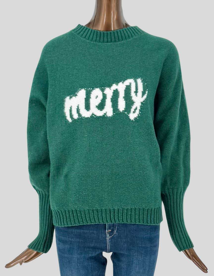 Authentic screen-worn SHEIN green Christmas sweater featuring white "Merry" knitted-in lettering, balloon sleeves, and extended ribbed cuffs.