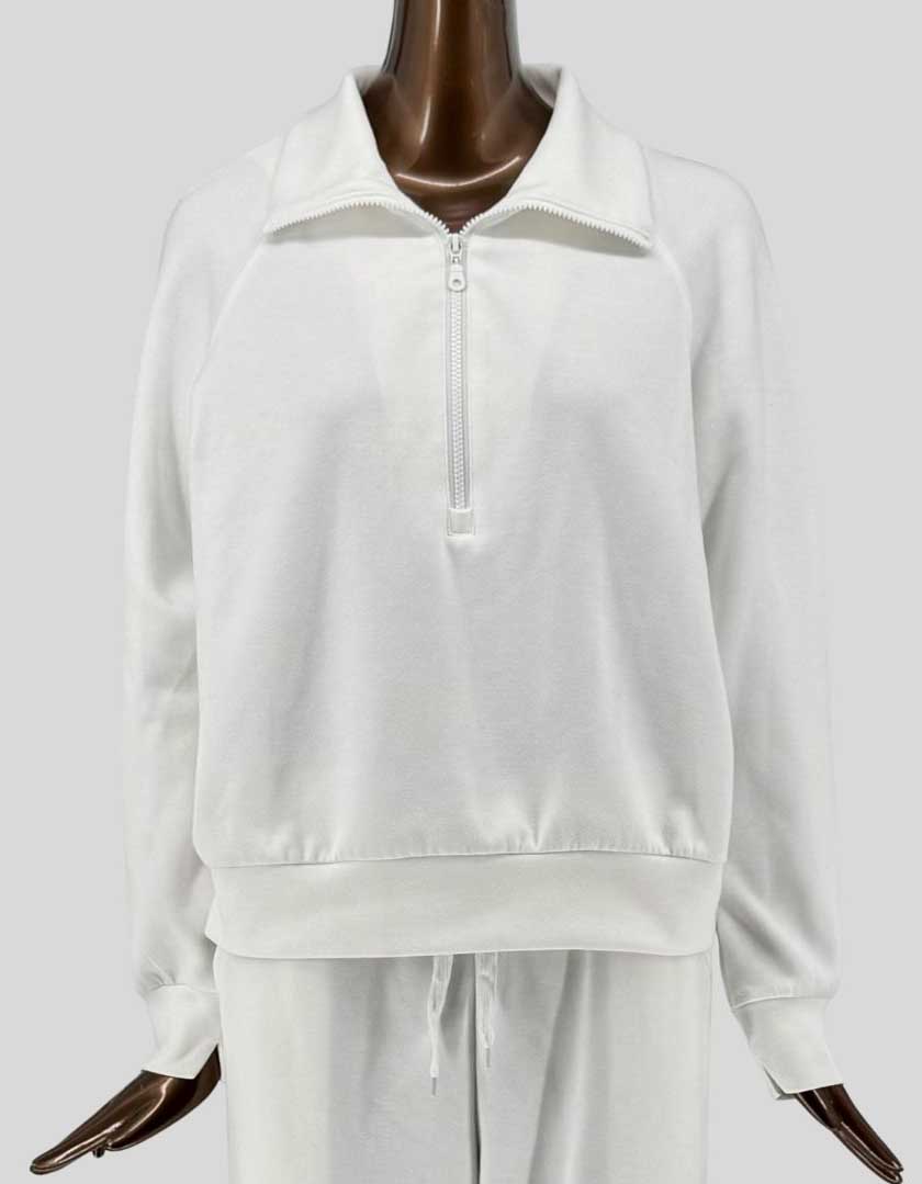 Authentic screen-worn PRETTYGARDEN white/cream two-piece loungewear set featuring a half-zip pullover sweatshirt with stand collar and matching drawstring sweatpants. 