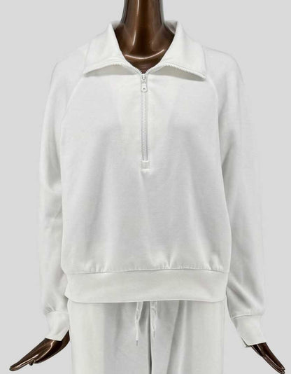 Authentic screen-worn PRETTYGARDEN white/cream two-piece loungewear set featuring a half-zip pullover sweatshirt with stand collar and matching drawstring sweatpants. 