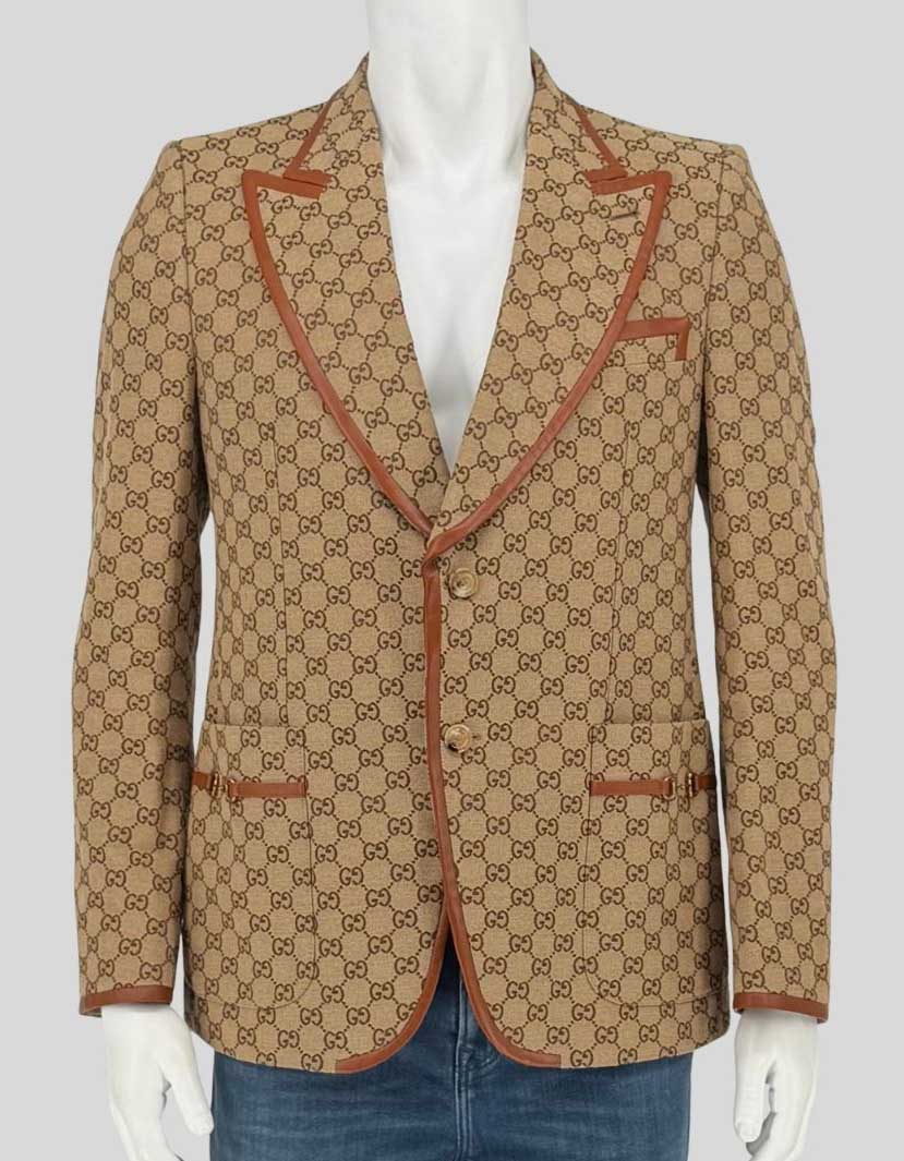 Authentic screen-worn Gucci GG canvas blazer featuring signature beige/ebony monogram pattern with contrasting tan leather trim. Single-breasted design with horn-effect buttons 