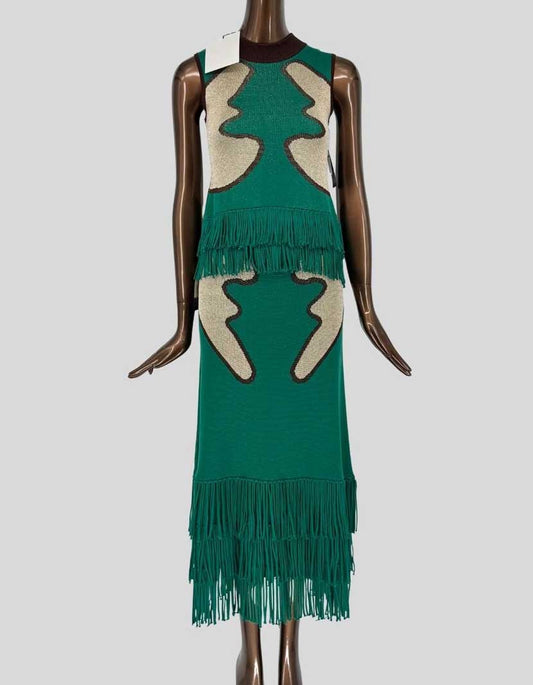 Authentic LUKHANYO MDINGI emerald green knit ensemble featuring coordinating cream intarsia abstract motifs with brown trim detail throughout. Set includes sleeveless top with crew neckline and tiered fringe hem, plus matching midi skirt with elastic waistband and tiered fringe hem. 