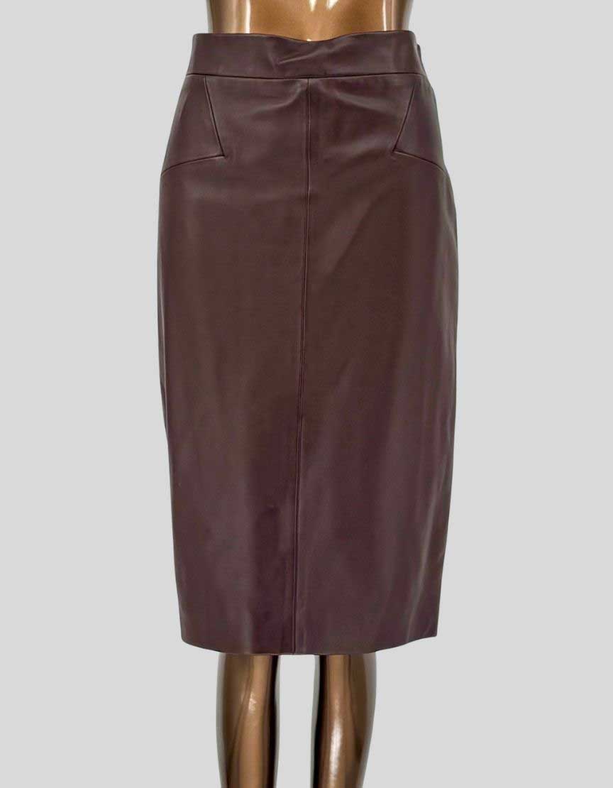 Authentic REISS burgundy leather pencil skirt featuring high-rise waistband, center front seam detail, side pockets, and back zipper closure with vent. Fully lined. 