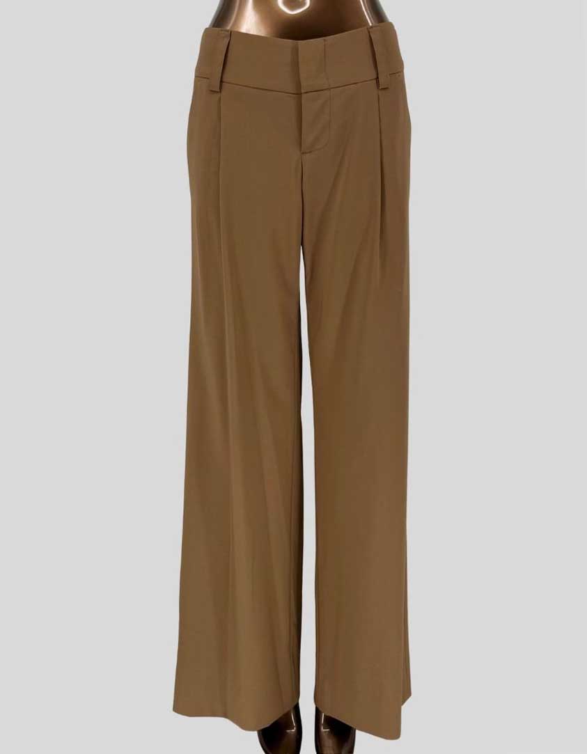 Authentic screen-worn Alice + Olivia wide leg pants in tan/khaki. Wide leg trousers feature front pressed creases, high-rise waistband, and signature A+O red contrast stitching detail.