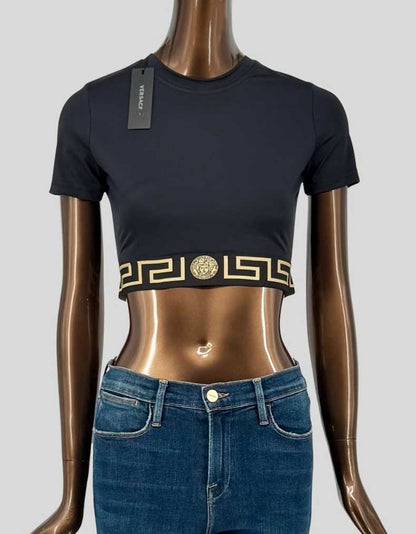 Authentic Versace Greca crop top in black with signature gold Medusa head and Greek key motif waistband. Features crew neck, short sleeves, and elasticated logo underband.