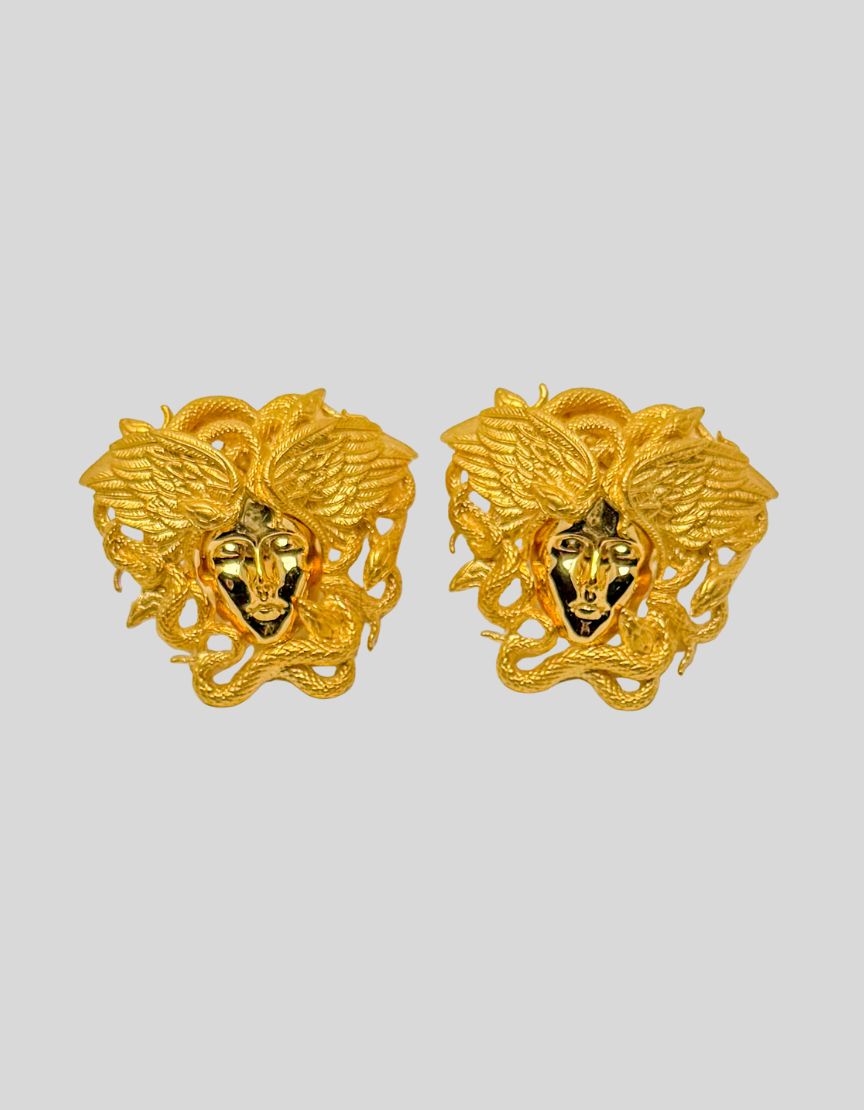 VERSACE Gold-Tone Tribute Medusa Stud Earrings. Iconic Medusa head design with intricate serpentine detailing. Three-dimensional sculptural effect. Hypoallergenic materials.