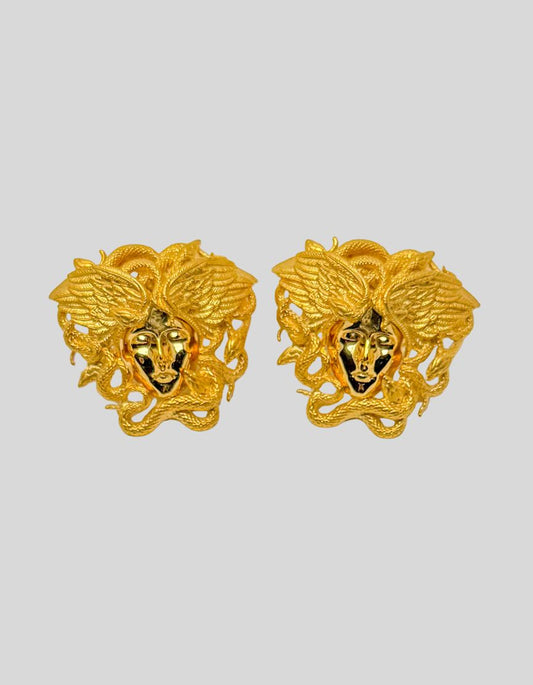 VERSACE Gold-Tone Tribute Medusa Stud Earrings. Iconic Medusa head design with intricate serpentine detailing. Three-dimensional sculptural effect. Hypoallergenic materials.