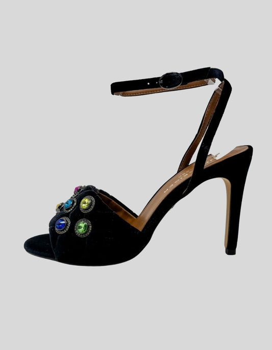 KURT GEIGER Chelsea ankle strap heels in black velvet. Features multicolor jeweled embellishments across toe strap, slender ankle strap with adjustable buckle closure, stiletto heel. 