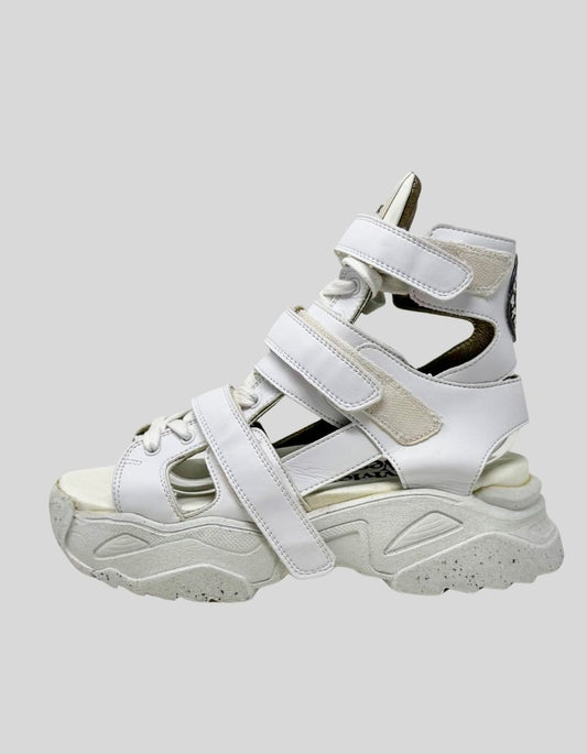 VIVIENNE WESTWOOD leather gladiator platform sandals in white. Features multiple velcro straps in high-top design, chunky platform sole with speckled terrazzo pattern, premium leather construction. 