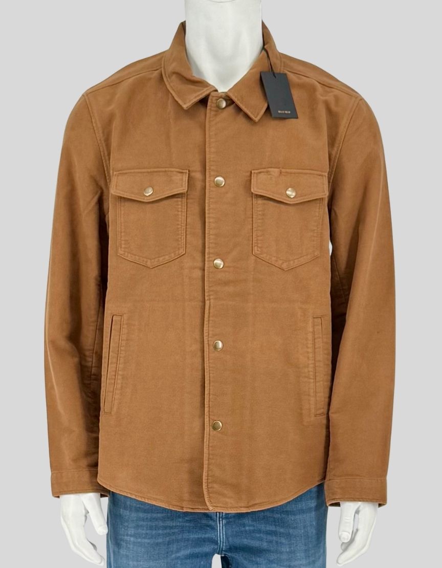  BILLY REID tobacco moleskin shirt jacket combining the lightness of a shirt with the structure of a jacket. Crafted from 100% cotton moleskin with an ultra-soft hand feel, featuring double chest pockets with flap snaps, double-welt waist pockets, 