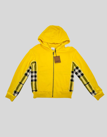 BURBERRY vibrant yellow zip-up hoodie featuring the house's iconic check panel detailing. Cotton-blend jersey with a soft brushed interior. Yellow, black, and white check panels run along the sleeves. 
