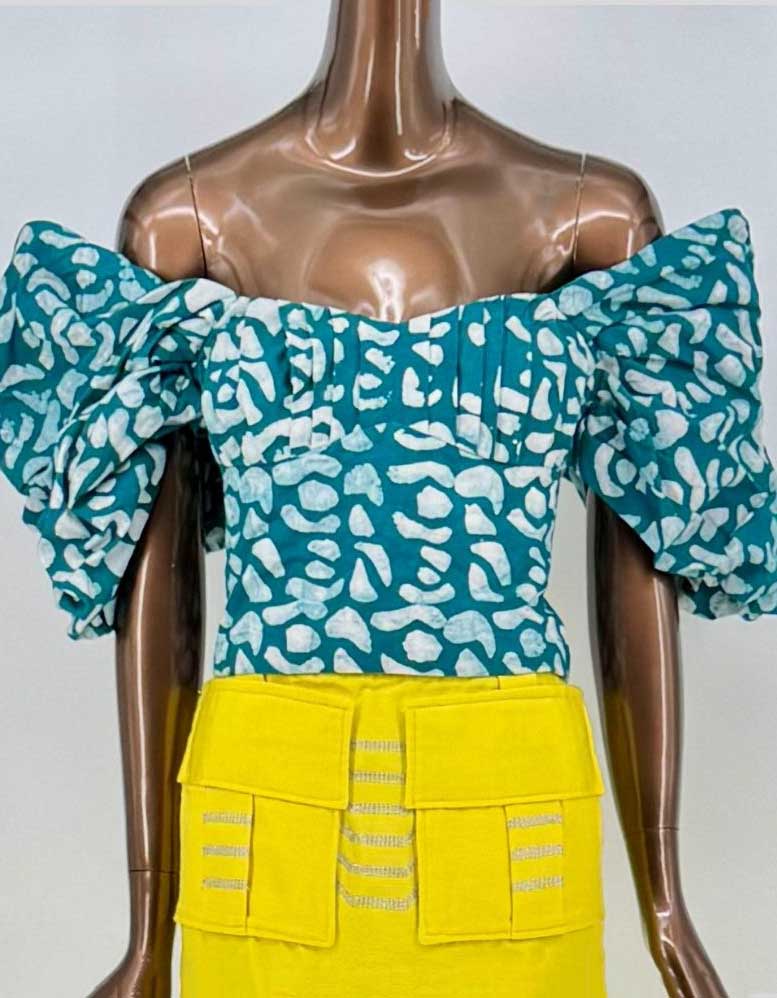 SILKA Abstract Print Off-Shoulder Ruffle Crop Top. Vibrant teal base with abstract white print creates eye-catching geometric pattern. Exaggerated ruffled sleeves add theatrical volume. Fitted bodice with concealed back zipper.