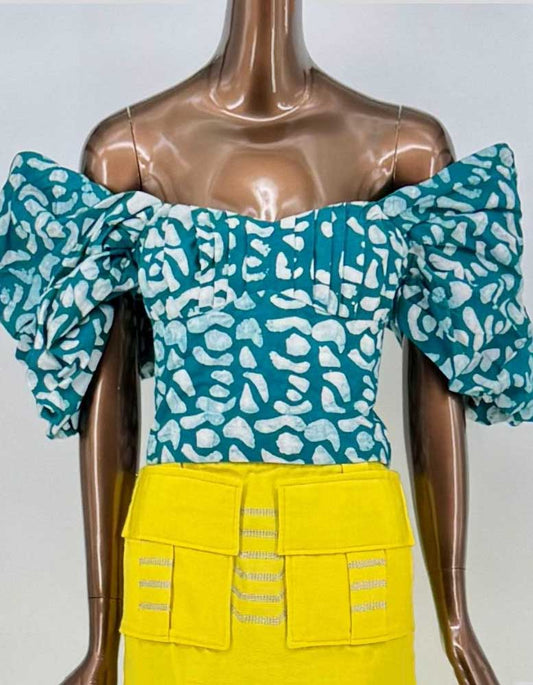 SILKA Abstract Print Off-Shoulder Ruffle Crop Top. Vibrant teal base with abstract white print creates eye-catching geometric pattern. Exaggerated ruffled sleeves add theatrical volume. Fitted bodice with concealed back zipper.