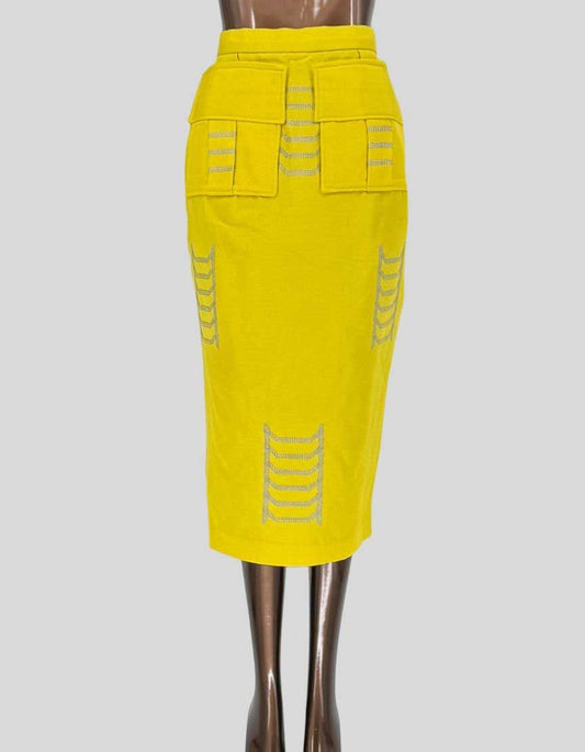EMMY KASBIT striking midi pencil skirt from the Nigerian luxury fashion house. Vibrant canary yellow base with silver embellished ladder detailing creating architectural lines. High-waisted silhouette with front utility pockets 