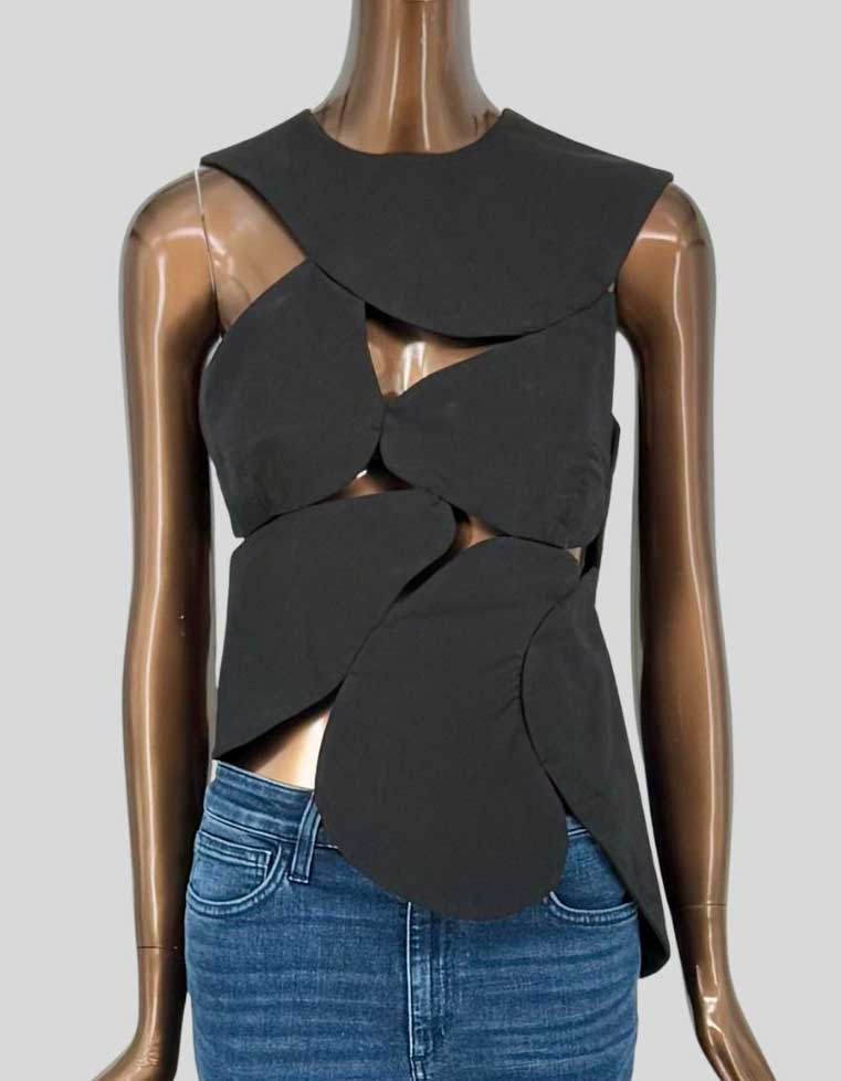 A.W.A.K.E. MODE architectural cutout top featuring dramatic interwoven panels. Sculptural design creates abstract negative space. Sleeveless construction with asymmetric hem. 100% cotton. Avant-garde London-based label known for Japanese-inspired conceptual designs. Unlined. 