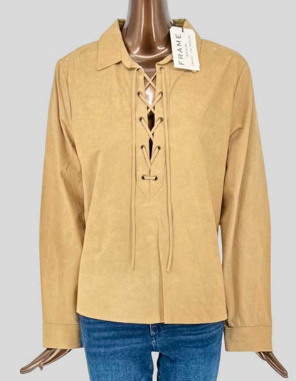 FRAME buttery soft suede pullover shirt in warm tan featuring a striking lace-up front with leather cord detailing. Classic spread collar and long sleeves with barrel cuffs. 