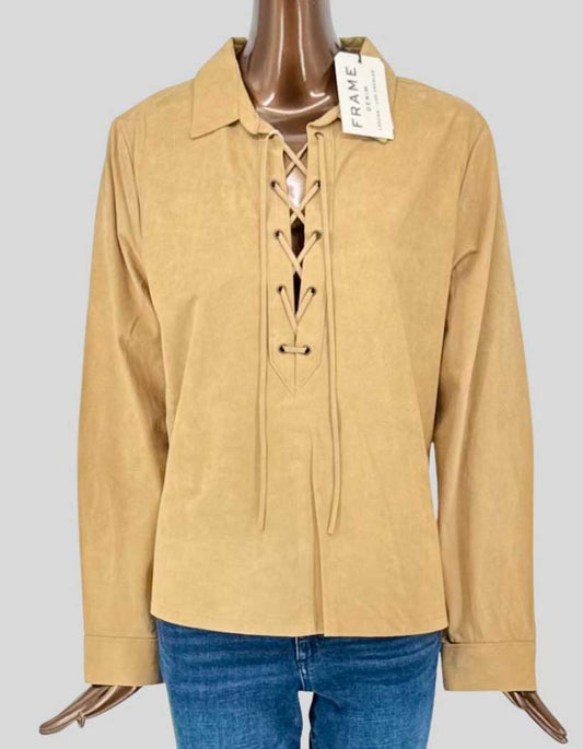 FRAME buttery soft suede pullover shirt in warm tan featuring a striking lace-up front with leather cord detailing. Classic spread collar and long sleeves with barrel cuffs. 