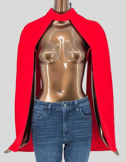 SAFIYAA dramatic red bolero featuring the brand's signature sculpted silhouette with high standing collar and striking open front. Flowing cape sleeves with slit openings create elegant movement and red-carpet impact.