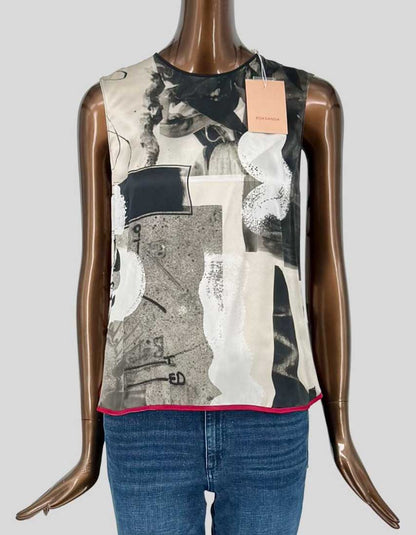 ROKSANDA sleeveless top features a striking abstract collage print in grey, black, cream, and white tones with a contrast fuchsia pink hem. High-Lo design. Round neckline, relaxed silhouette.