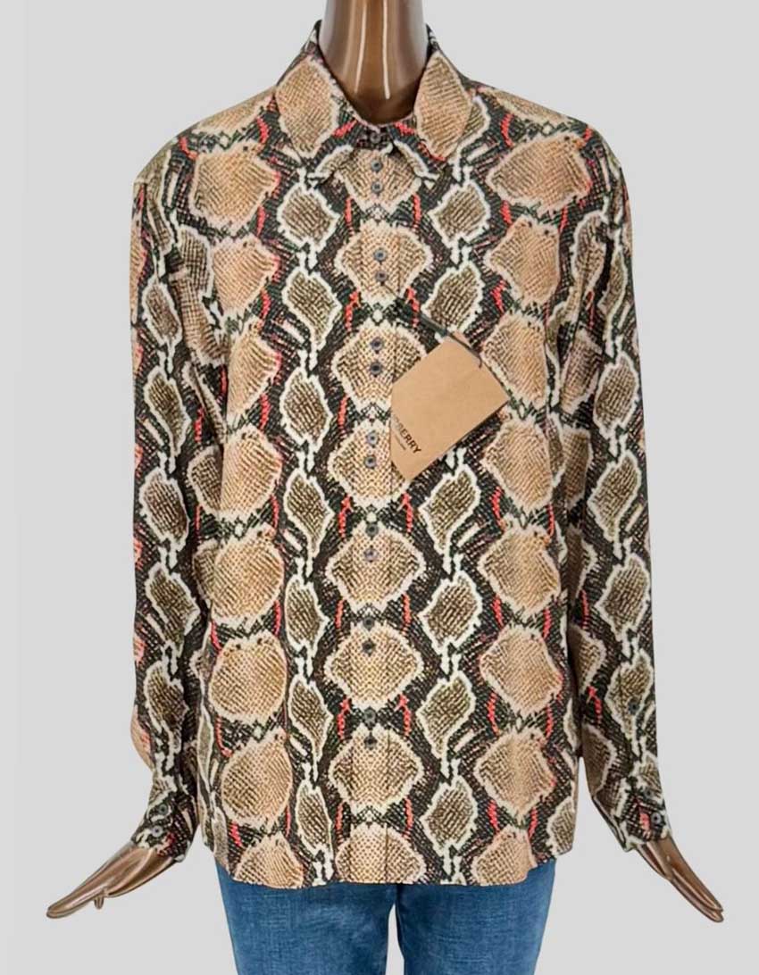 BURBERRY's Carlota blouse in luxurious silk features a striking python print in tones of tan, brown, black, and coral red. Point collar, button front closure, chest patch pocket, long sleeves with button barrel cuffs, relaxed fit, shirttail hem.
