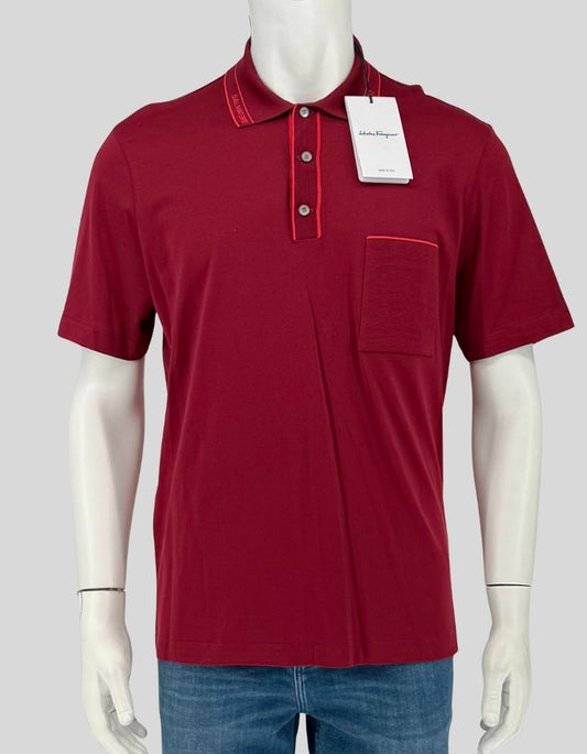 SALVATORE FERRAGAMO polo shirt in rich melagrana (pomegranate) with signature "SALVATORE" logo-embroidered collar. Contrast red piping at placket and chest pocket, three-button placket, short sleeves.