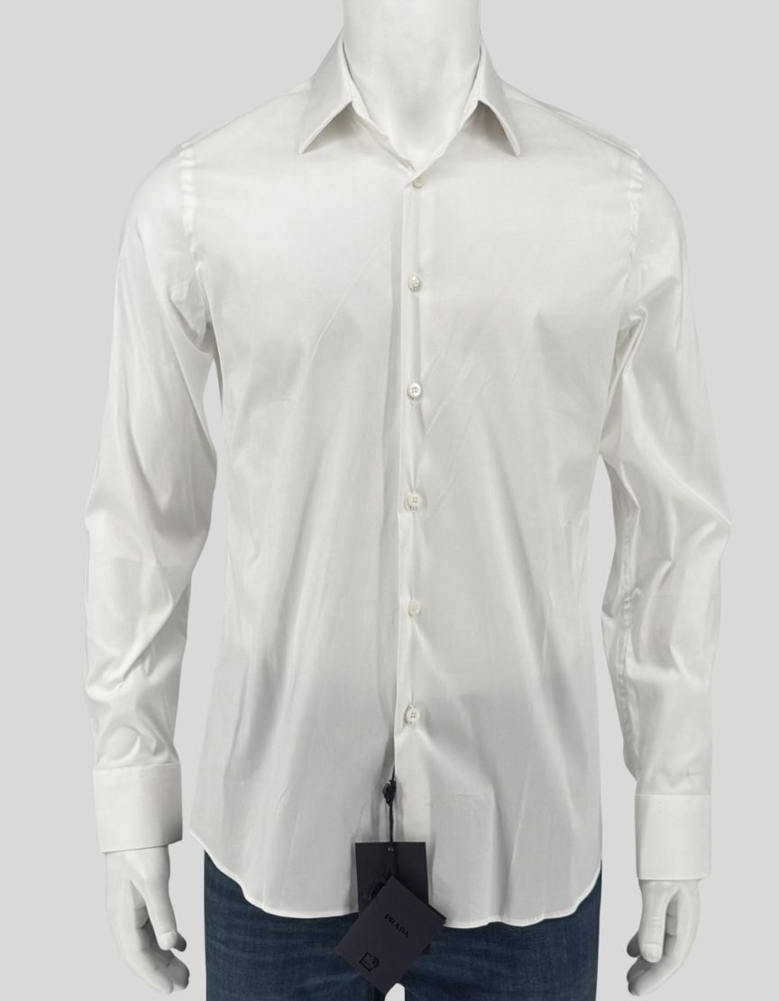 PRADA stretch poplin dress shirt in white (Bianco). Slim fit silhouette with classic spread collar, long sleeves, and mother-of-pearl button front closure. Tailored darts at back for a refined, body-skimming cut. Rounded hem. 
