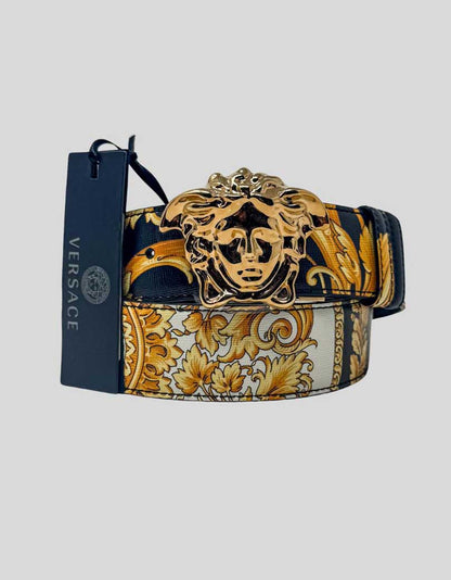 VERSACE reversible belt in signature Baroque print on luxurious calf leather. One side features the iconic gold Baroque acanthus leaf motif on black and ivory, while the reverse offers solid black leather for versatile styling. Crowned with the sculptural gold-tone La Medusa head buckle