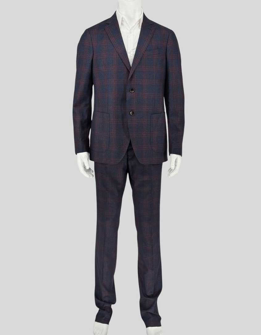 ETRO wool suit in navy with burgundy windowpane plaid. Single-breasted jacket features notched lapels, two-button closure, flap pockets, and signature paisley-print lining. Coordinating flat-front trousers with open hem for custom tailoring. 