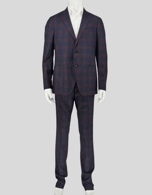 ETRO wool suit in navy with burgundy windowpane plaid. Single-breasted jacket features notched lapels, two-button closure, flap pockets, and signature paisley-print lining. Coordinating flat-front trousers with open hem for custom tailoring. 