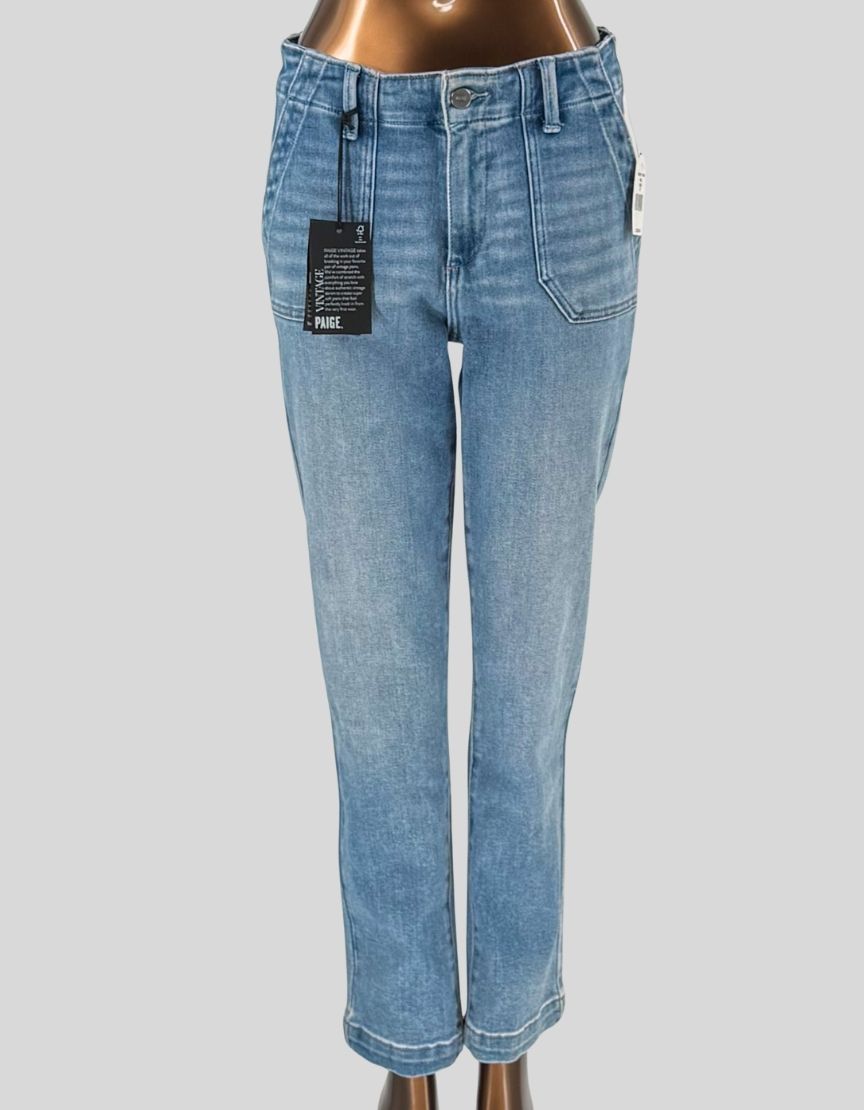 PAIGE Mayslie straight ankle jeans in "Mel" light blue wash. Mid-rise straight leg with utility patch pockets. Cropped ankle length with cuffed hem. Contrast white topstitching throughout. Made from stretch cotton denim. 
