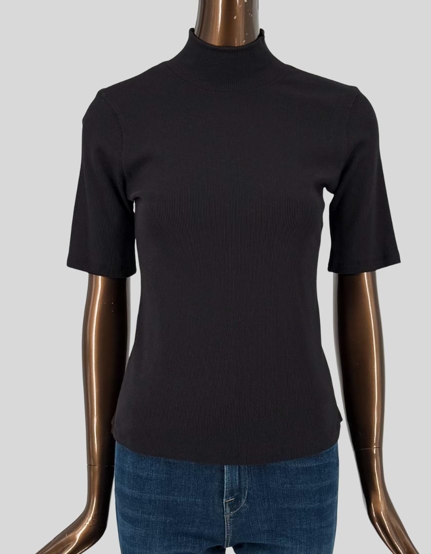 ELIE TAHARI ribbed knit mock neck top in black. Short sleeves with fine ribbed texture throughout. Mock turtleneck. Fitted silhouette. Slip-on styling. Made from soft, stretchy rib knit fabric.
