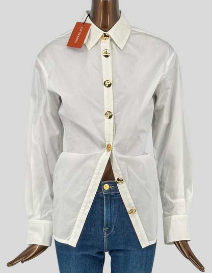ALTUZARRA button-front shirt in pristine natural white. Classic collar with modern twist: statement gold logo buttons create striking focal point. Long sleeves with button cuffs, tailored fit with princess seams for flattering silhouette. Extended hem with subtle side splits.