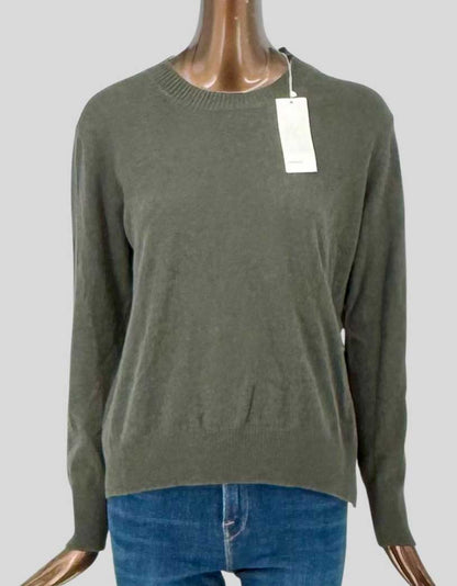 VINCE crew neck sweater in 100% cashmere with olive green finish. Ribbed crew neckline, long sleeves with ribbed cuffs, and ribbed hem. Relaxed fit construction. Tie closure design on left side. Arrives new with all original tags attached.