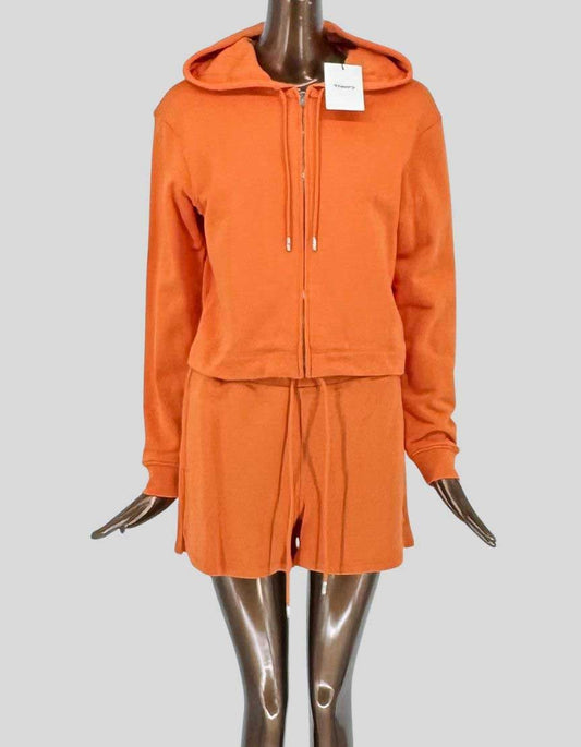 THEORY two-piece set in 100% cotton with vibrant orange finish. Zip-front hoodie with adjustable drawstring hood, full-zip closure, long sleeves with ribbed cuffs, and ribbed hem. Matching shorts with drawstring elastic waist and side pockets. Complete set arrives new with all original tags attached. 