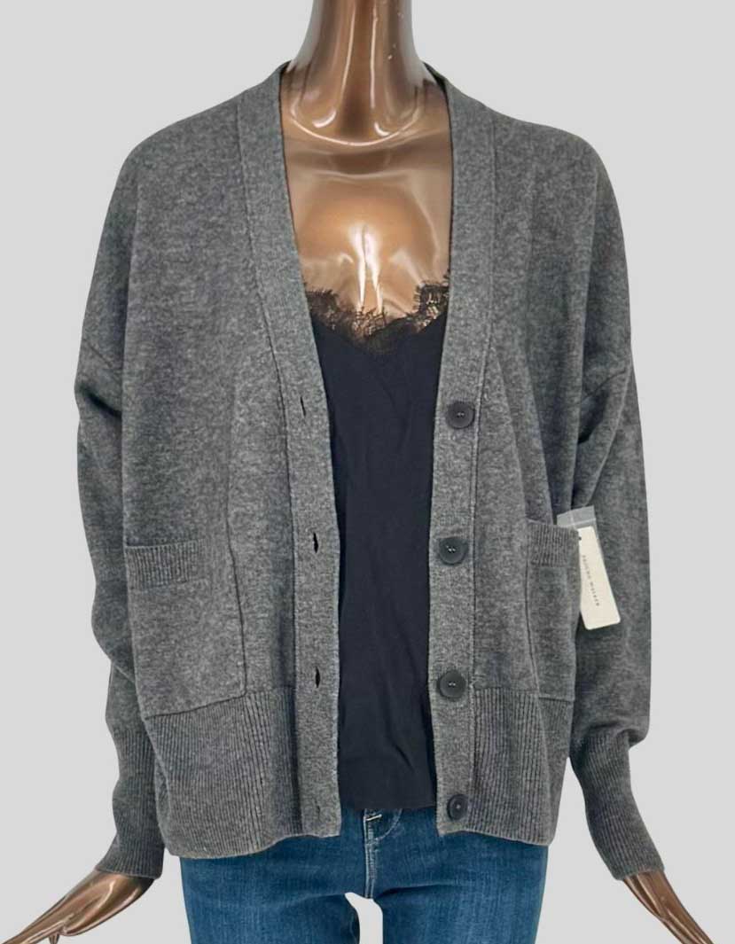 BROCHU WALKER Lace Looker cardigan in charcoal grey with 70% wool and 30% cashmere blend. V-neckline with four-button closure. Signature lace detail panel at center front attached to sweater for layered effect. Two patch pockets at front. 